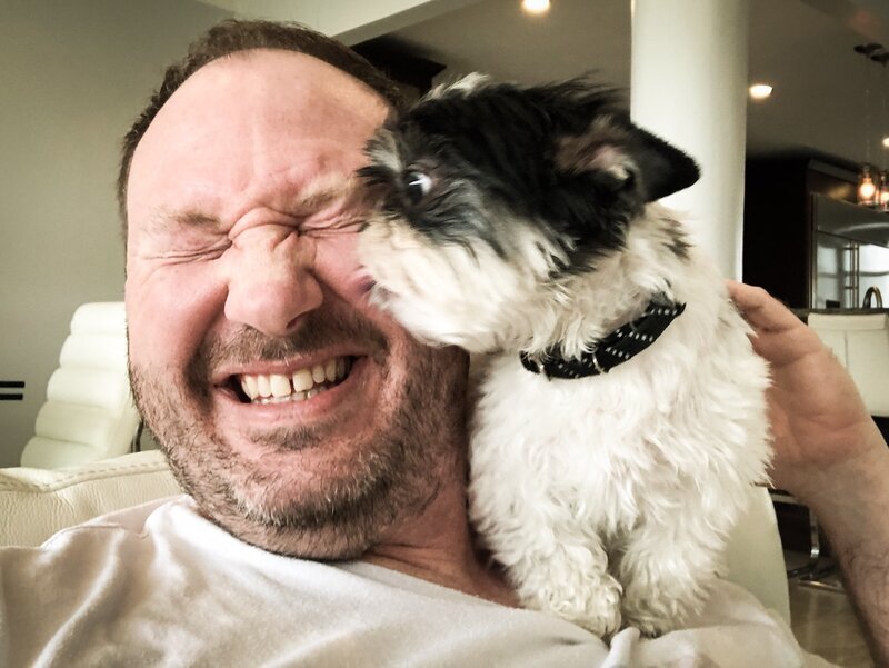 Small Shih Tzu mix giving happy kisses in the living room at Beach House Bliss OC dog sitting, Orange County